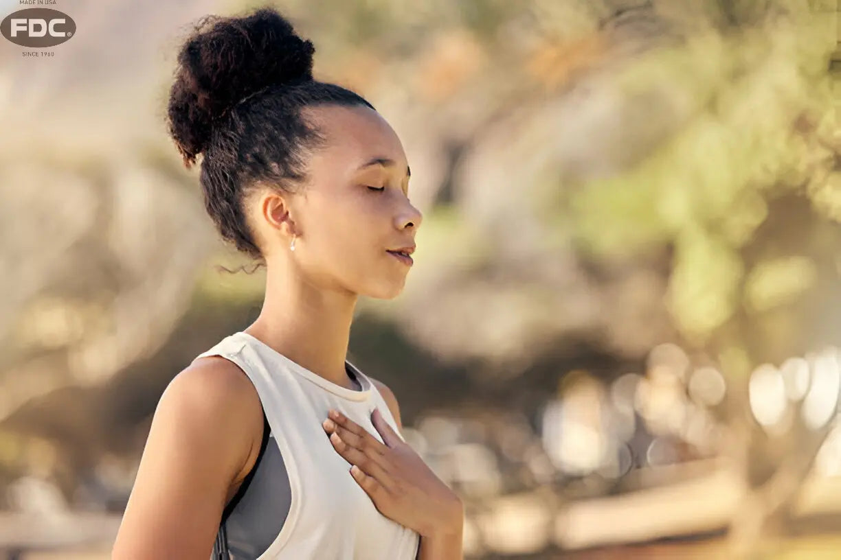 Texto alternativo:Mulher praticando mindfulness ao ar livre, com foco na respiração e relaxamento.