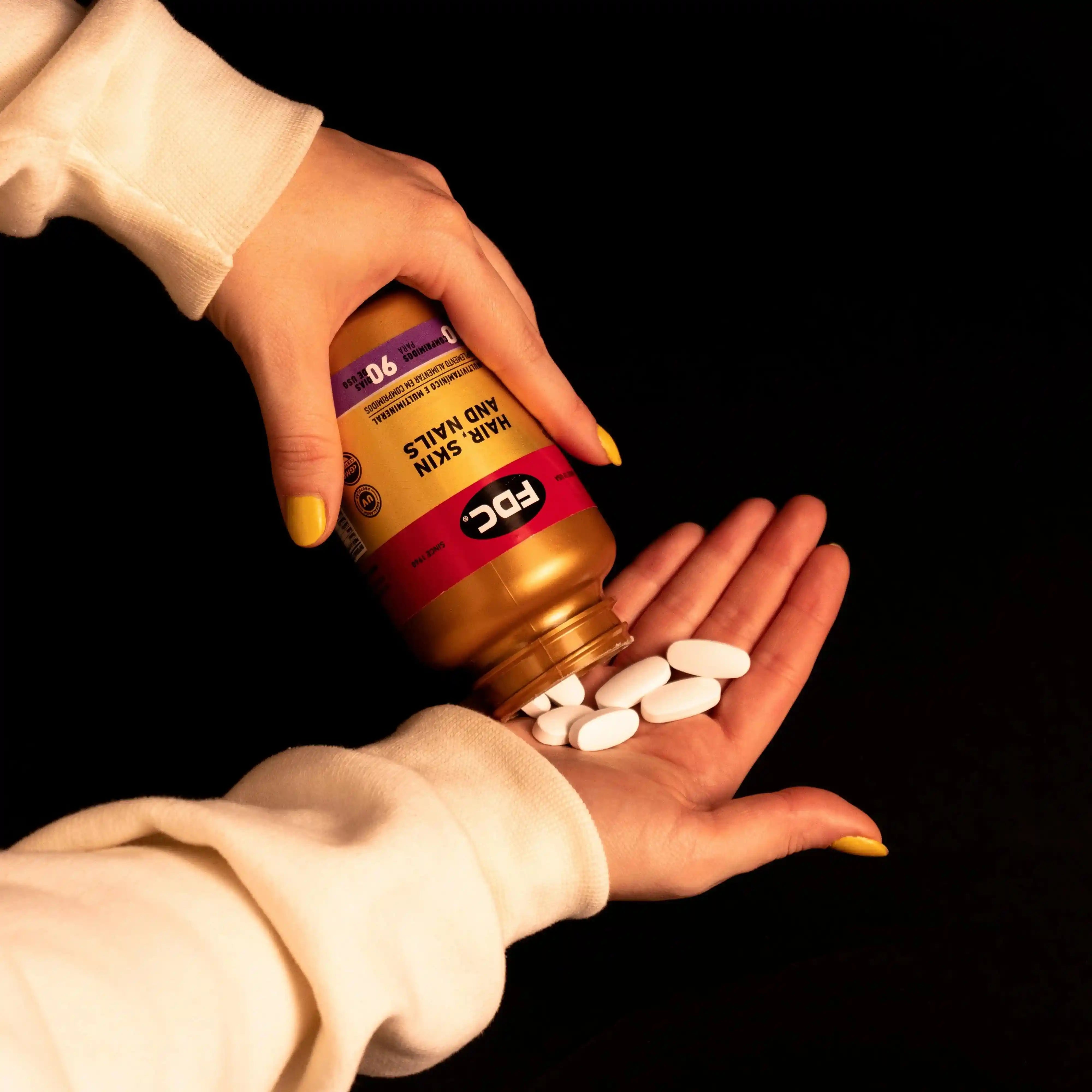 a person holding a bottle of pills in their hands