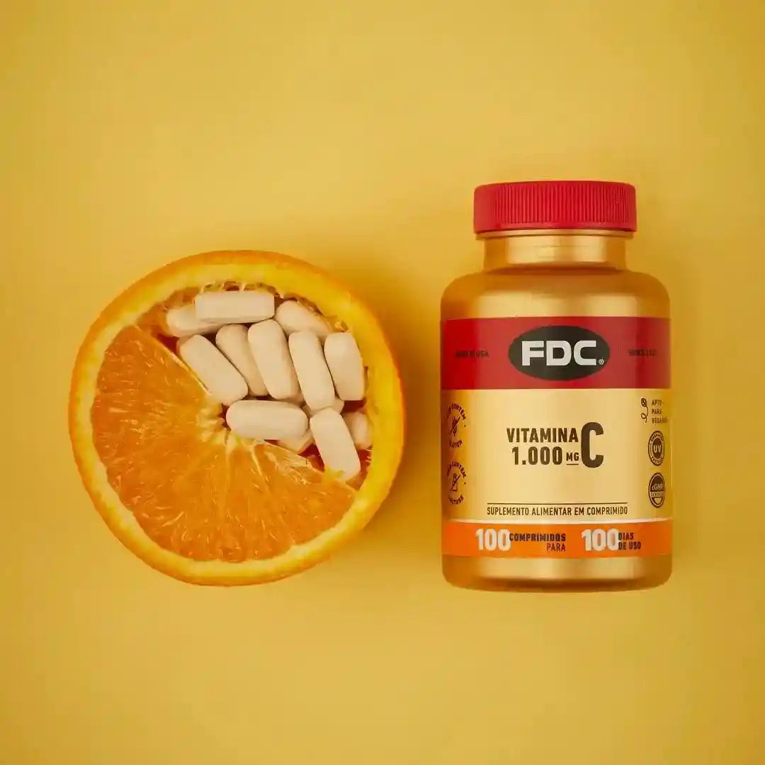 a vitamin pill next to an orange on a yellow background