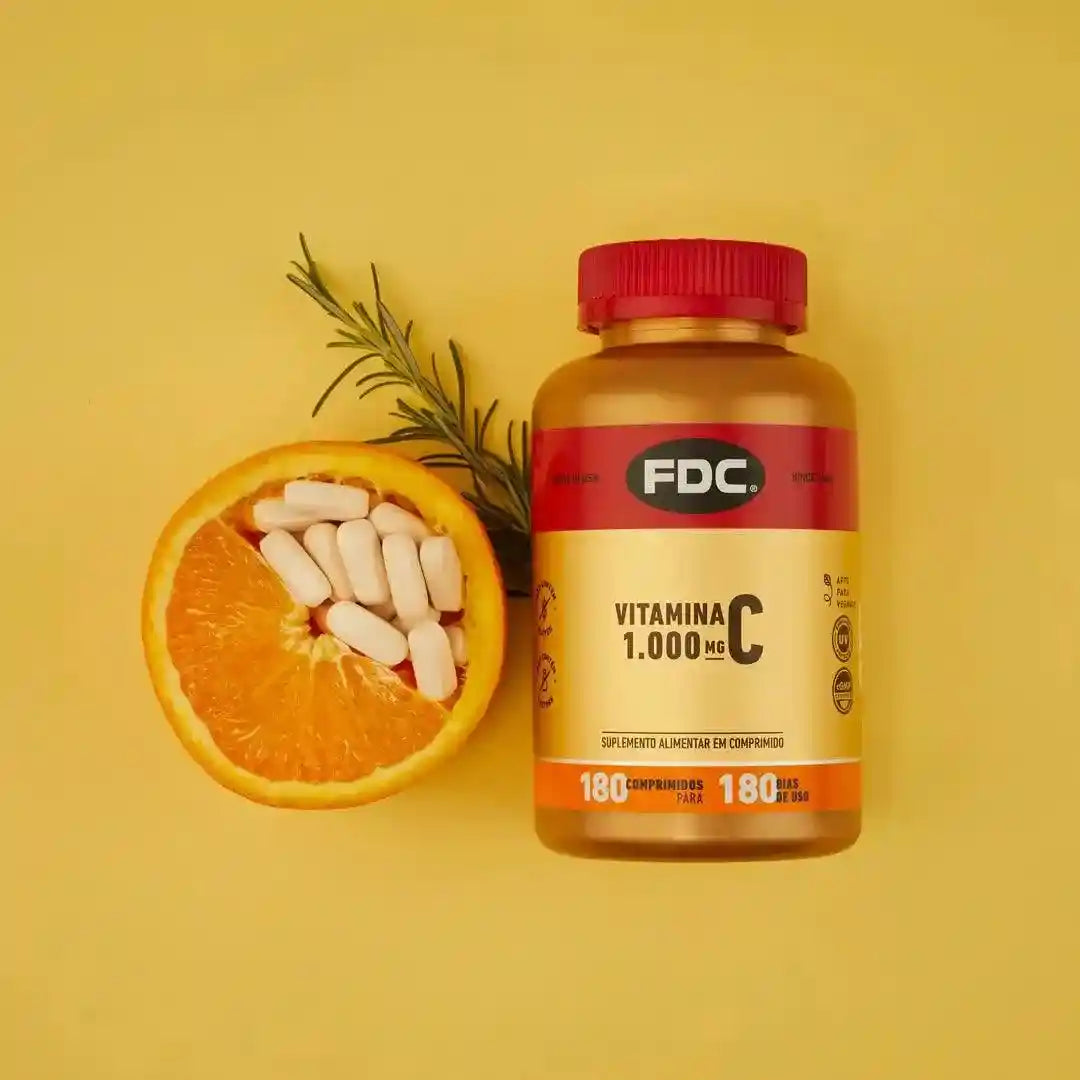 a vitamin pill next to an orange on a yellow background