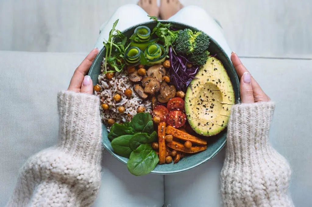 Texto alternativo:Tigela nutritiva com vegetais, abacate, grãos e legumes, ideal para dieta vegana.