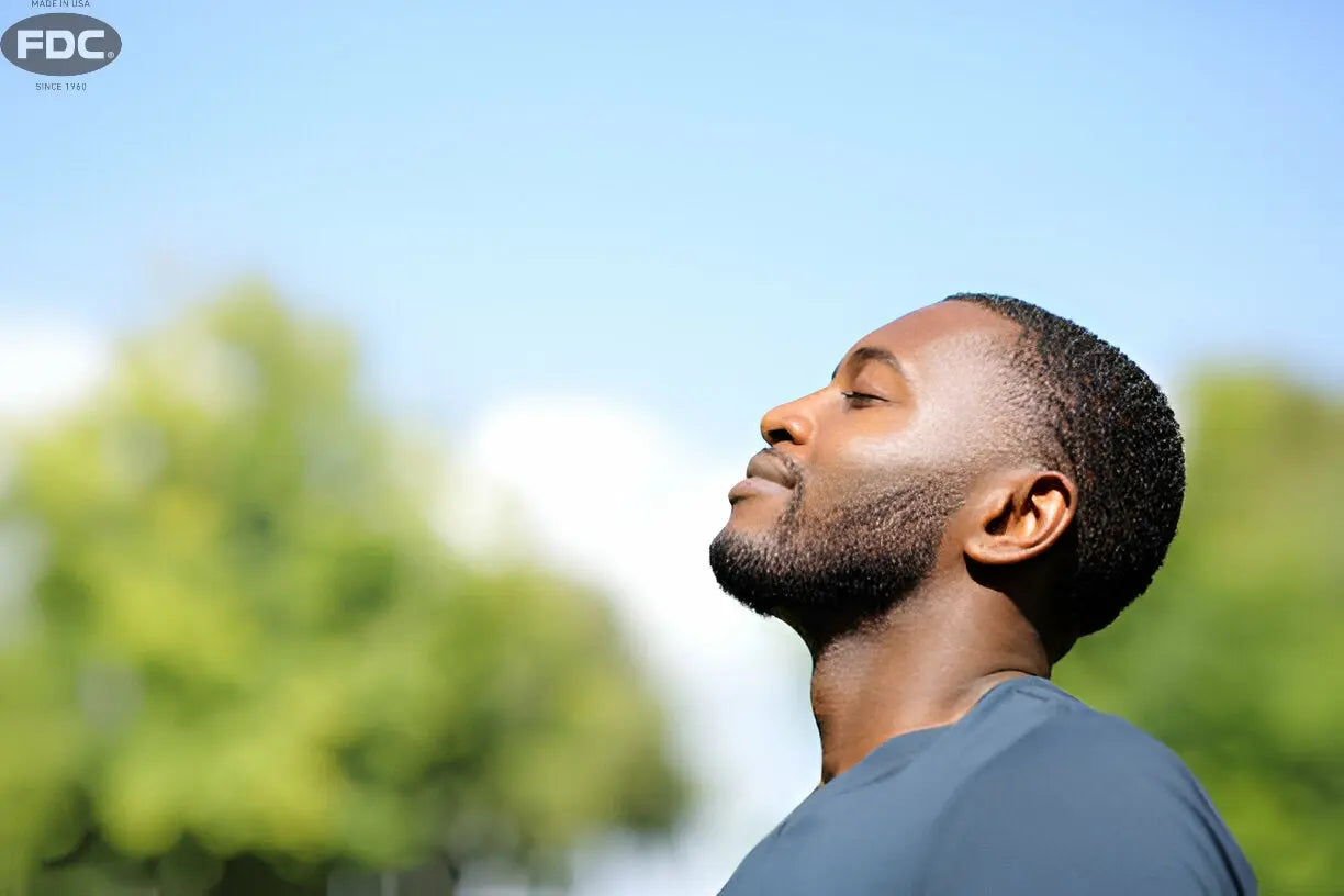 Texto alternativo:Homem aproveitando a luz solar, fonte natural de vitamina D, ao ar livre.