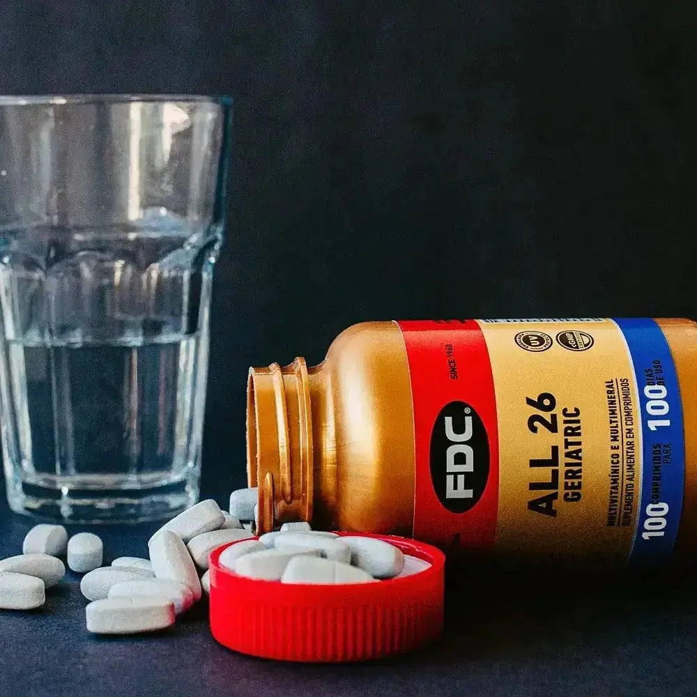 a bottle of pills next to a glass of water