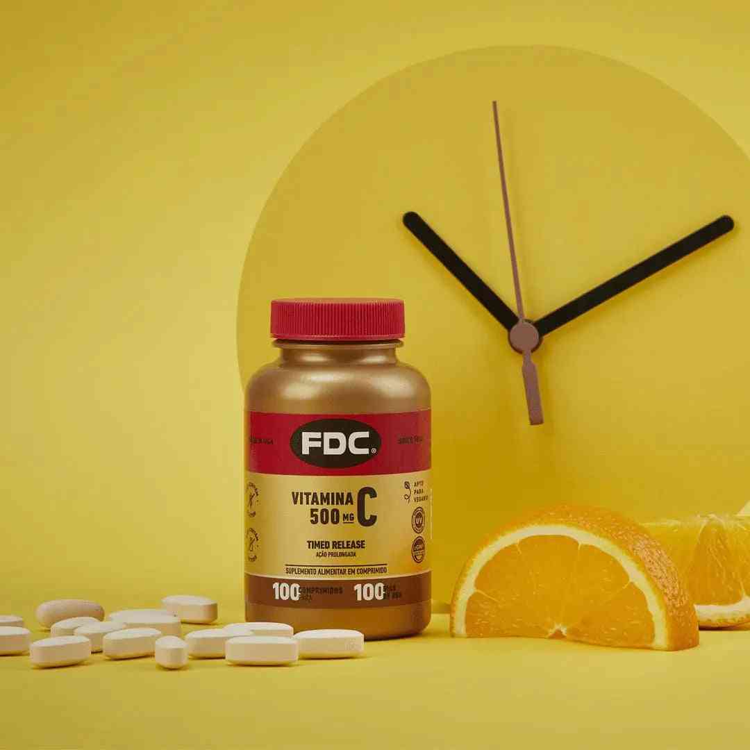 a clock with vitamin pills next to an orange